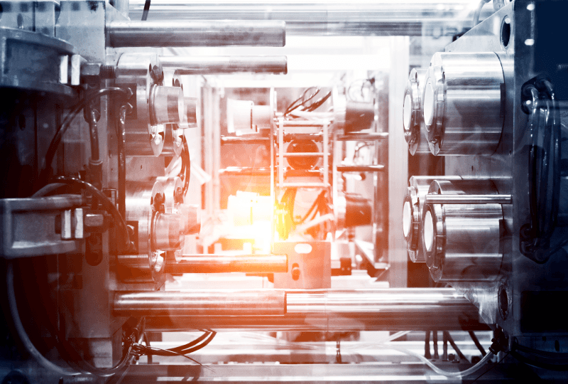Close-up of industrial machinery with metallic components and warm internal light